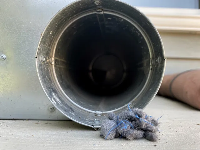 Ellington Dryer Vent Cleaning technician using specialized equipment to clear severe dryer vent blockage in Ellington